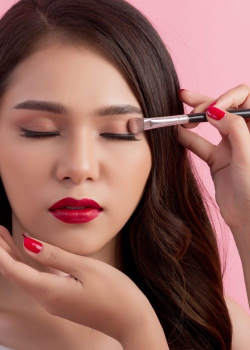 Make-up artist applying liquid eyeliner with brush, close up